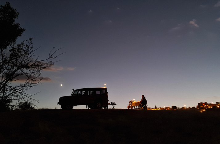 A person sitting at a table for custom night dining experience surrounded by distinctive fairy chimneys in a secluded valley in Cappadocia.