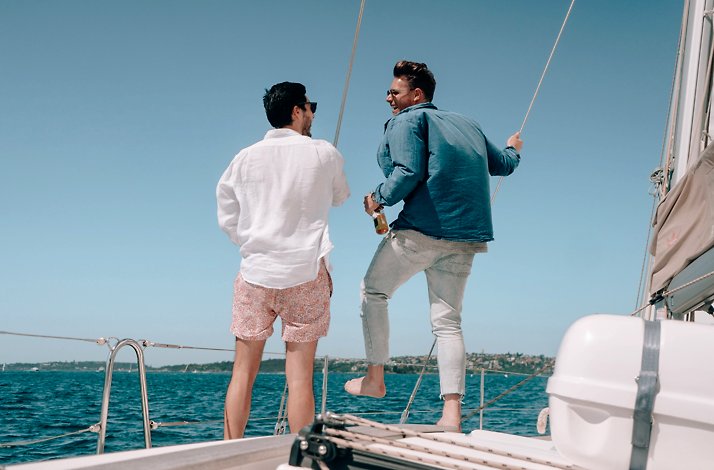 Two people with their back to the camera on a private yacht.
