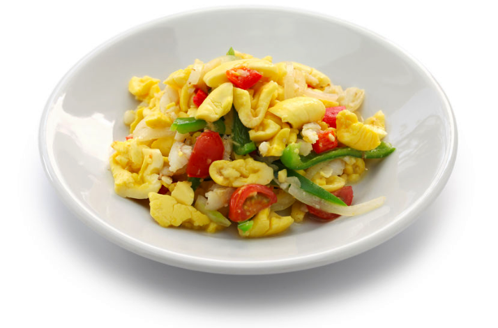 Ackee and saltfish dish with tomatoes, peppers, and onions, Jamaica’s national dish.