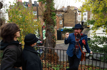 The image captures a moment during a guided walking tour in London. 