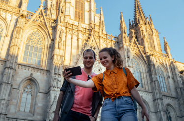 Tourists taking a selfie in front of Barcelona Cathedral.