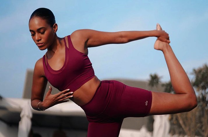 Photo of Adrienne Everett, an Alo wellness architect and founder of HWH Studio, doing yoga.