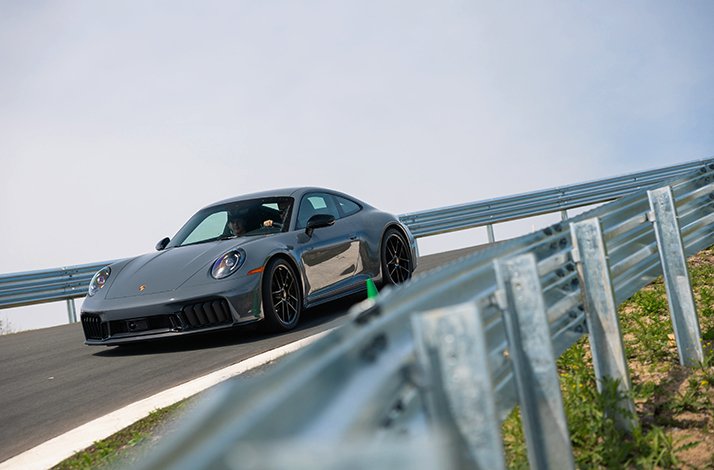 A Porsche 911 on a race lane during a drive experience on Porsche Experience Centre Toronto premises.