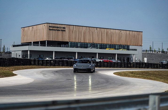 A Porsche 911 on a race lane during a drive experience on Porsche Experience Centre Toronto premises.