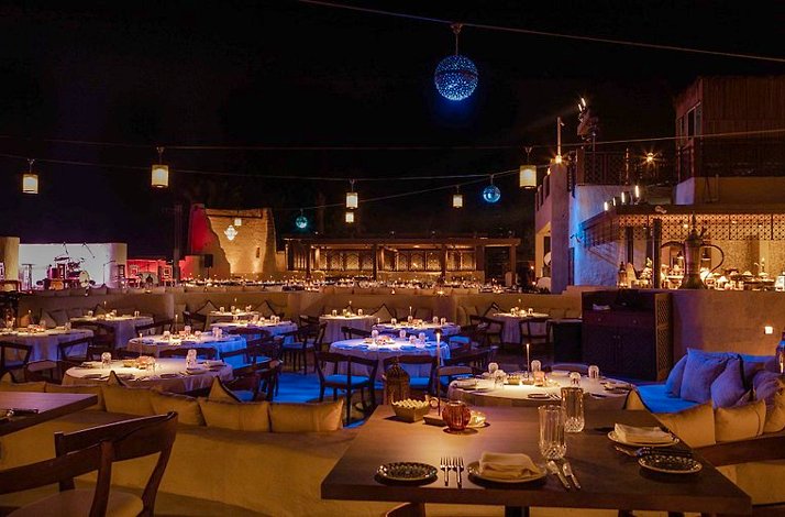 The large, elegant outdoor open-air dining area at Restaurant Al Hadheerah, featuring a deep night sky.