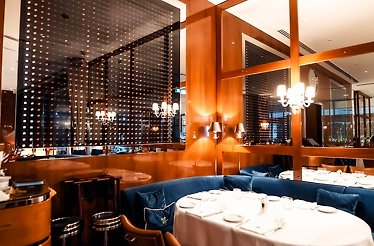 The sophisticated, nautical-inspired dining room overlooking the Marina at Restaurant Cipriani Dubai.