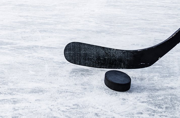 Promotional photo of a hockey puck and stick.