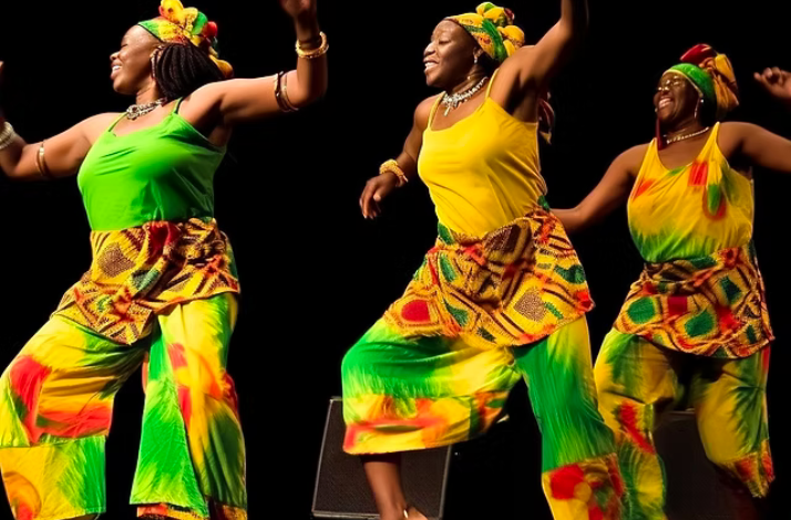 Three women in vibrant outfits joyfully dancing together in a lively setting.