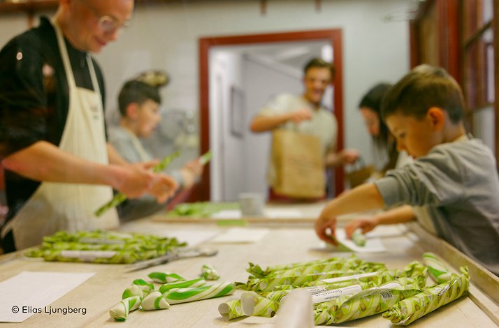 A group of people making handmade candy.  ©Elias Ljunberg
