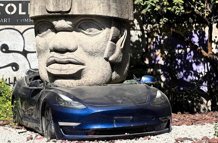 Art installation by the Mexican sculptor Chavis Mármol titled Neo-Ta Meme of a Tesla car with a huge sculpture 