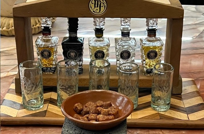 Different small Tequila bottles with snacks to be tested