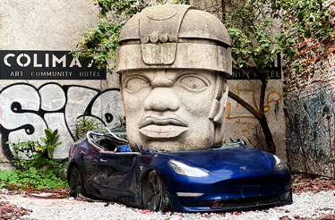 Art installation by the Mexican sculptor Chavis Mármol titled Neo-Ta Meme of a Tesla car with a huge sculpture