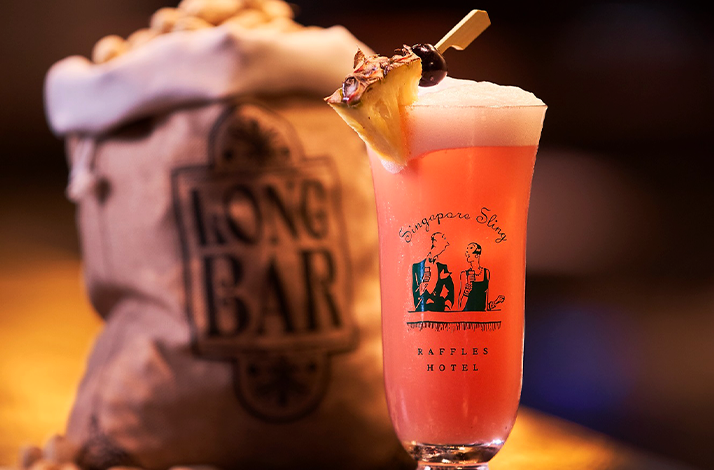 A glass of beer on the background of snacks in a bag.