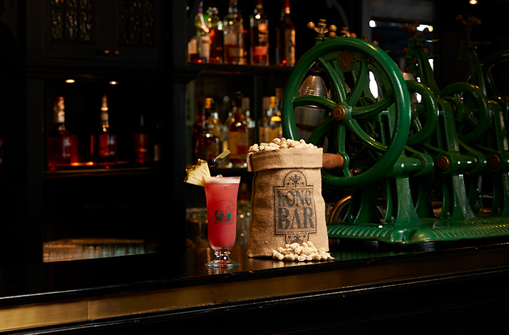 Singapore Sling and sack of peanuts with green vintage machines