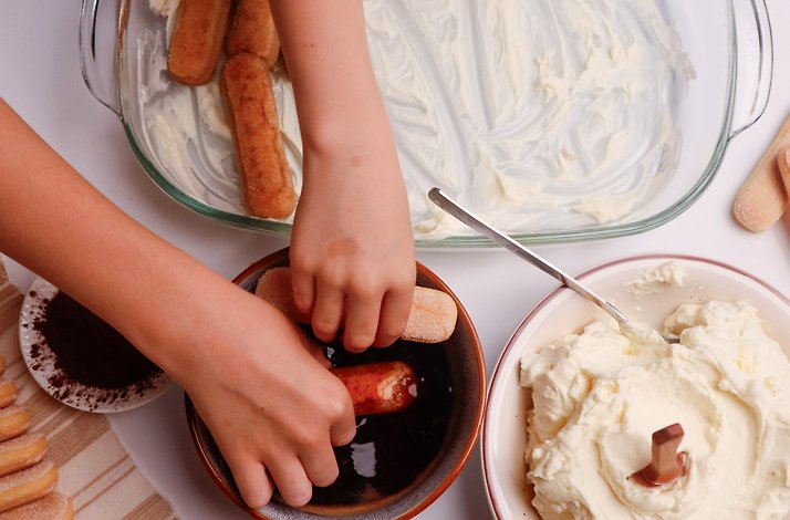 Someone making tiramisu from scratch