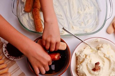 A child making tiramisu at a chef-led masterclass at Eataly Flatiron.