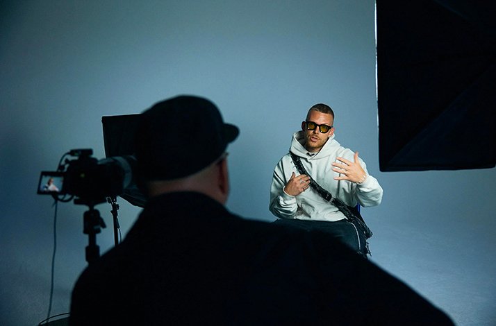 An interview shoot with a man in a hoodie and sunglasses being filmed at PLATTE Berlin.