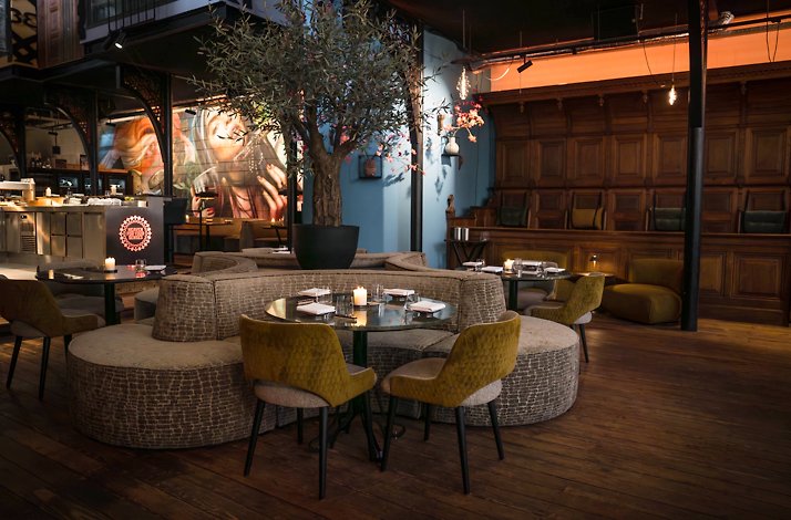 The beautiful dining area at boutique hotel The Church, featuring artistic decoration and graffiti art on a wall.