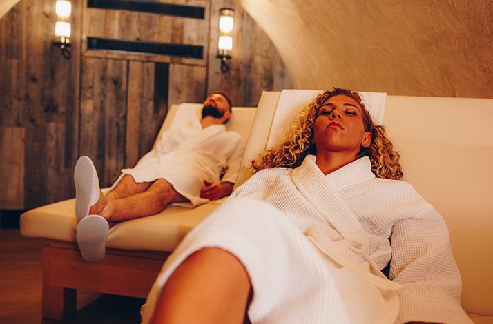 Two people relaxing in the heated lounge area at The Spa & Gym at The Edwardian Hotel Manchester.