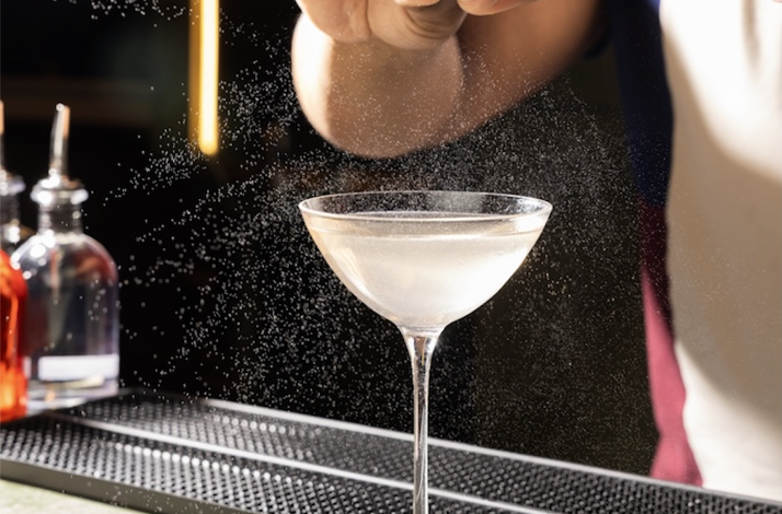 Cocktail preparation at immersive multisensory dining event.