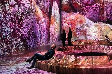 People gazing at illuminated room in purple and pink colors at Mercer Labs, New York.
