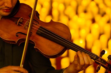 Musician performing at a Candlelight Concert.