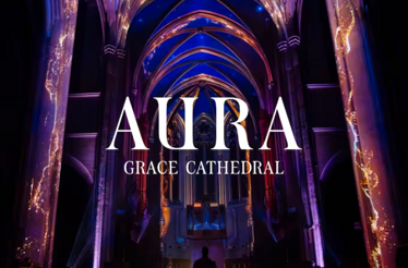Blue and purple light installation illuminates the interior of Grace Cathedral with the text AURA GRACE CATHEDRAL.