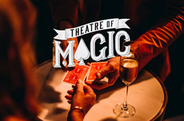 Close up of a person taking a card from a magician. Overlay text 'Theatre of magic'.