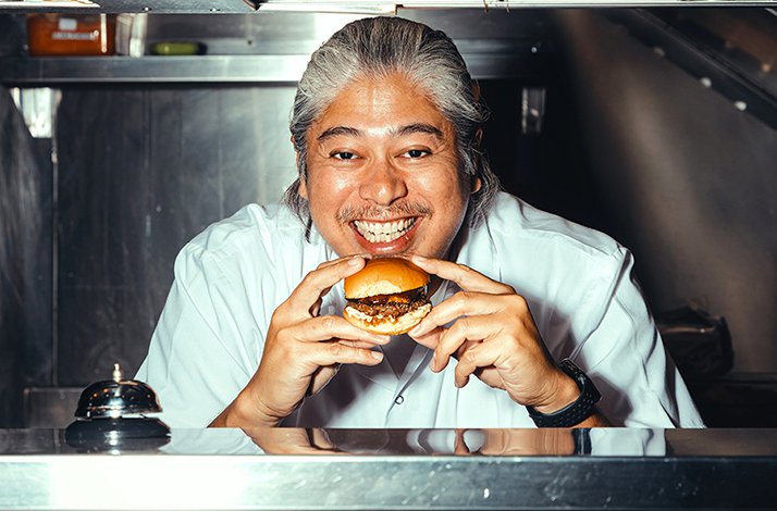 Chef in a kitchen preparing a dish, showcasing the culinary craftsmanship behind the Goldfish Bites experience.