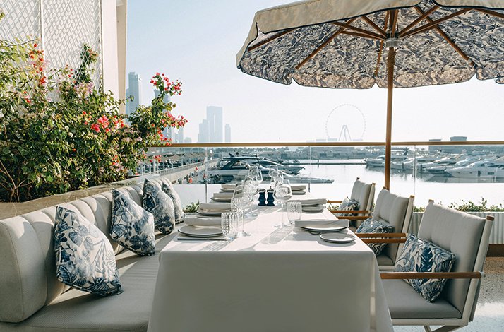 Outdoor table overlooking Dubai Harbour during the exclusive tasting menu experience.