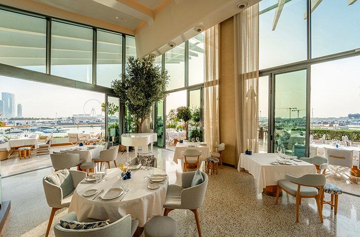 Elegant marina‑view dining room at L’Amo Bistro del Mare.