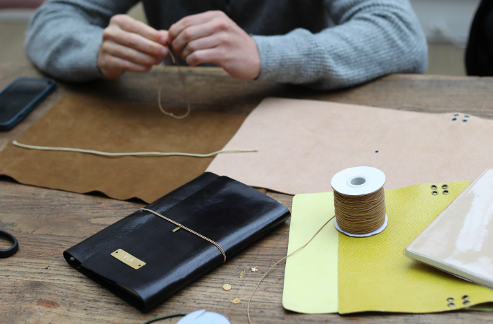 Participant crafting at  Notebook personalization workshop at Hôtel de Lauzun, Paris.