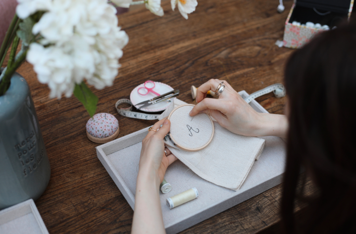 A woman at Embroidery on fabric workshop at Hôtel de Lauzun, Paris.