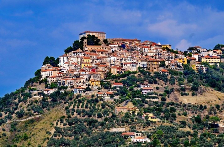 Hilltop town with clustered houses and greenery below
