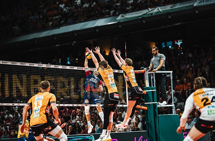 Basketball players in action during a game, showcasing dynamic movement on the court.