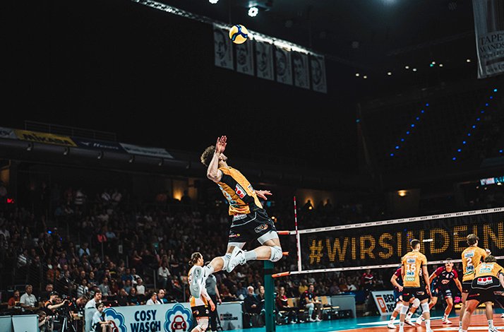 Basketball players in action during a game, showcasing dynamic movement on the court.