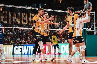 Basketball players in action during a game, showcasing dynamic movement on the court.