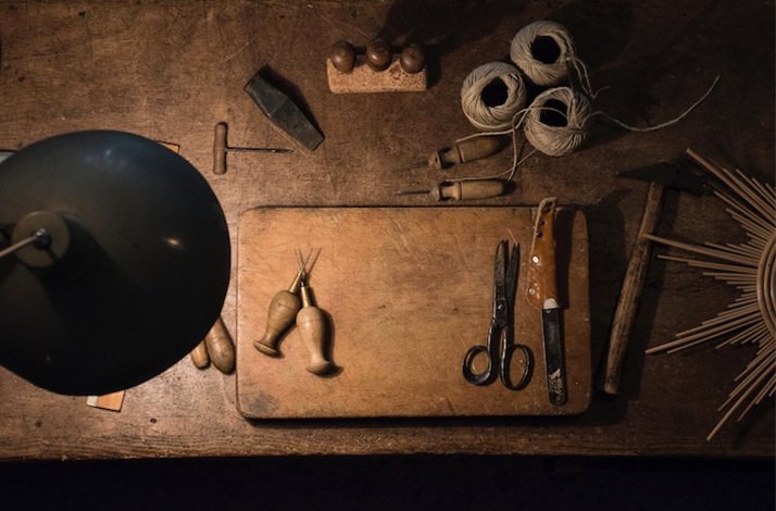 A table displaying various tools alongside a lamp, creating a workspace atmosphere.