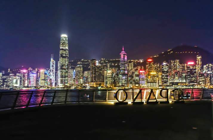 The view on the Hong Kong's scenic harbour skyline at night, featuring PANO letters