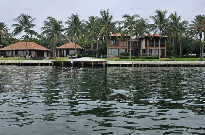 Waterfront homes with palm trees viewed from the bay.
