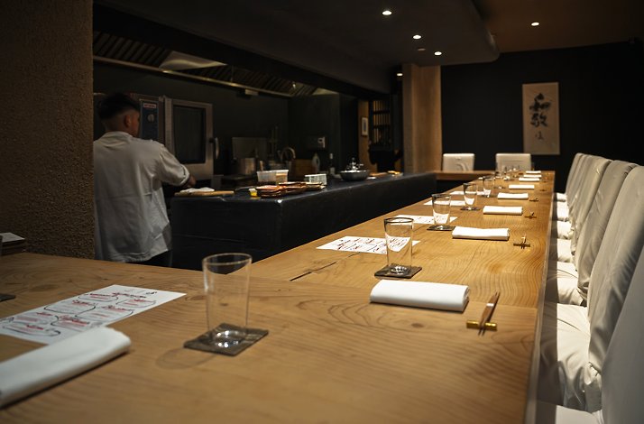 Long wooden dining table at the Gallery by Odo restaurant in New York.