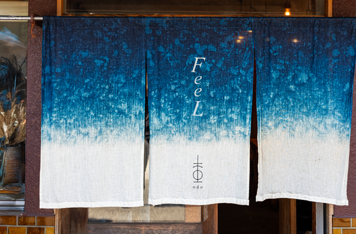 The curtains in Odo restaurant, with the word Feel written on them, and  with restaurant Odo logo