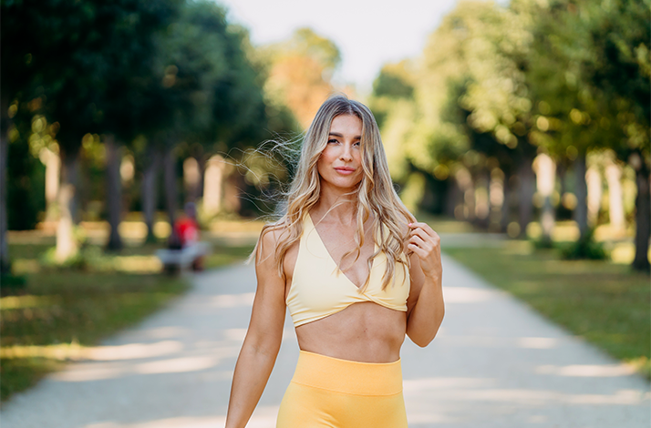 Fitness influencer Katja Believe posing on the street.