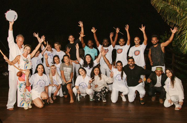 Group photo of participants celebrating after the capoeira workshop.