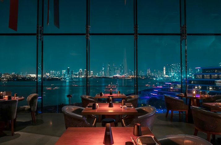 Akira Back restaurant featuring panoramic windows with a city view.