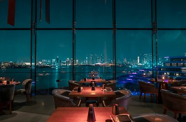 Akira Back restaurant featuring panoramic windows with a city view.