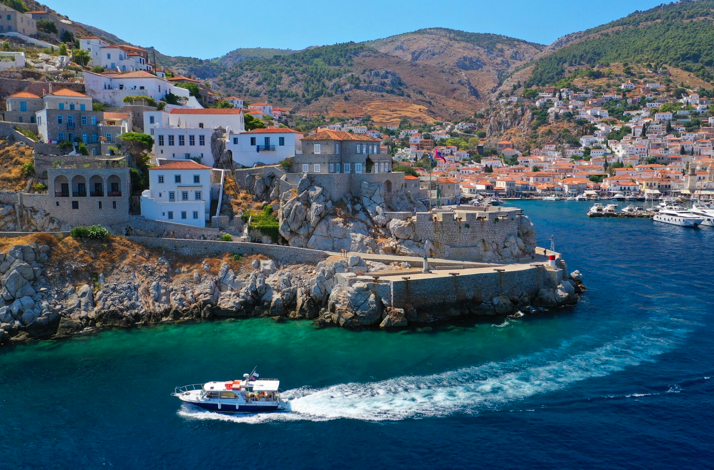 View of Bellevalia Hydra and Hydra port with boats and traditional houses on the island of Hydra.