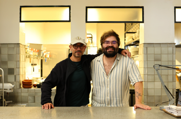 Nicocina and Chef Alejandro Gutíerrez, stand together at the counter of an open kitchen, ready to welcome guests into a warm and contemporary setting