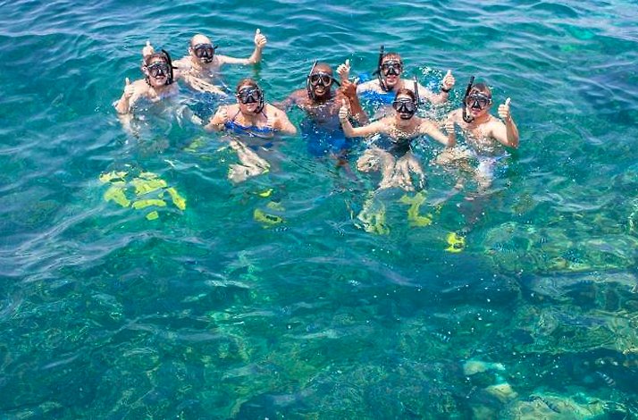 Group of snorkelers in clear water, Menai Bay Conservation Area, Zanzibar.