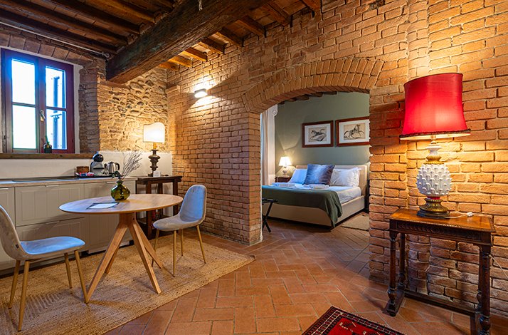 Interior of Origine Country Farm guest room and dining area, Tabiano, Parma countryside.
